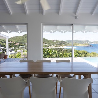 Your bright dining space opens to breathtaking ocean views, where morning coffee and sunset dinners become unforgettable moments.