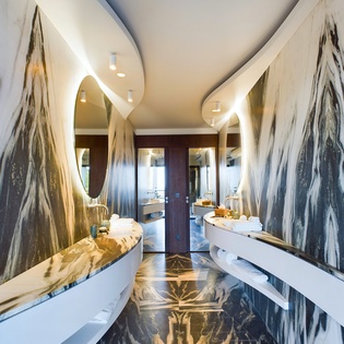 Step into your marble sanctuary featuring dramatic veining, sculptural mirrors, and floating vanities that create an unforgettable spa experience.