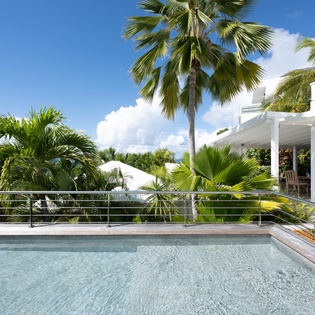 Slip into crystal-clear waters surrounded by swaying palms and tropical gardens, your private slice of paradise awaits.