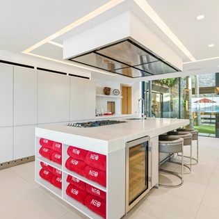 Your sleek modern kitchen features a stunning island with gas cooktop, perfect for creating memorable meals together.