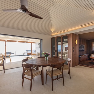 Gather around your elegant dining table while ocean breezes flow through sliding doors to your private terrace.