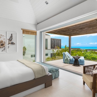 Wake up to stunning ocean views from your private bedroom sanctuary, where tropical breezes flow through open doors to your terrace.