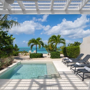 Your private oasis with a sparkling pool overlooking turquoise waters and swaying palms, perfect for soaking up Caribbean bliss.