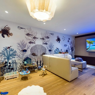 Your family can unwind in this magical underwater-themed playroom, where whimsical sea life murals create an immersive ocean adventure.