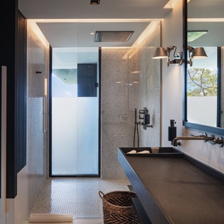 Step into your luxurious spa-like bathroom with rainfall shower, elegant mosaic tiles, and modern dual vanities.