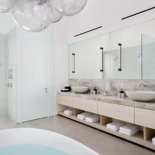 Indulge in your private spa-like sanctuary with a soaking tub, dual vanities, and rain shower for pure relaxation.