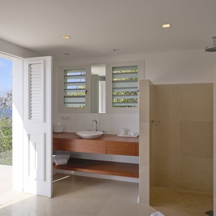 Unwind in your spa-like ensuite with tropical garden views and a refreshing rain shower.