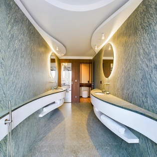 Step into your spa-like bathroom sanctuary, where sculptural marble walls and ambient lighting create the perfect retreat for relaxation.