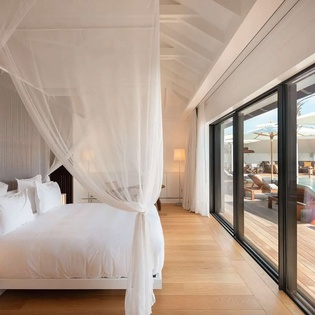 Step into your private sanctuary with a canopy bed and direct access to your terrace with pool, where warm sunshine and peaceful relaxation await.