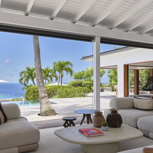 Unwind in your airy living space where plush seating and calming ocean blues invite total relaxation. The seamless indoor-outdoor flow opens to an infinity pool and endless sea views.