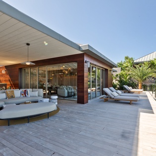 Unwind on your private terrace where modern comfort meets tropical luxury, featuring designer loungers and seamless indoor-outdoor living.