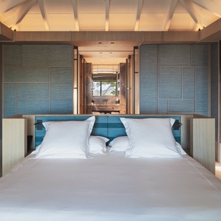 Drift to sleep in your luxurious overwater bedroom, where crisp linens and stunning ocean views create the perfect tropical sanctuary.