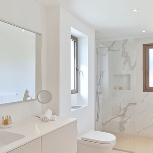 Indulge in your private marble sanctuary where luxury meets comfort—your own spa-like retreat with rainfall shower awaits.