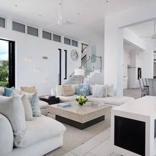 Relax in your bright, open-concept living space with soaring ceilings, plush seating, and tropical garden views—the perfect spot to unwind after a day of adventure.
