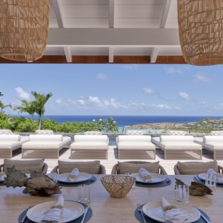 Elegant outdoor dining with ocean views and tropical breezes through your covered terrace setting.