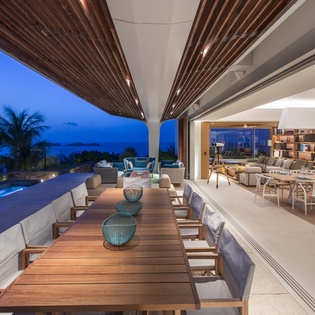 Unwind in this stunning open-air dining space where tropical breezes flow through seamlessly blending indoor luxury with breathtaking ocean views.