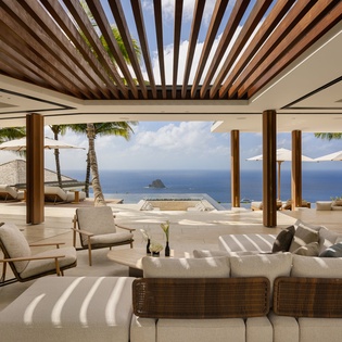 Unwind in your open-plan living space where modern luxury meets tropical serenity, with stunning ocean views framing your perfect getaway.