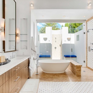 Your private spa-like sanctuary features a luxurious soaking tub, dual vanities, rainfall shower, and an open-air courtyard—modern elegance meets total relaxation.