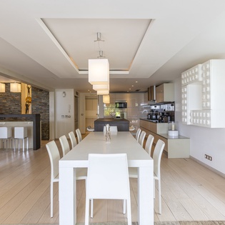 Step into this bright, open-plan space where your group can gather around the sleek dining table, share meals prepared in the fully equipped modern kitchen, and unwind together in refined comfort.