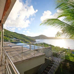 Step onto your private terrace and soak in breathtaking ocean views framed by swaying palms and tropical mountains.