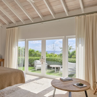 Wake up to tropical greenery and peaceful skies framed by floor-to-ceiling glass doors. Your private terrace beckons just steps away, perfect for morning coffee or sunset wind-down.