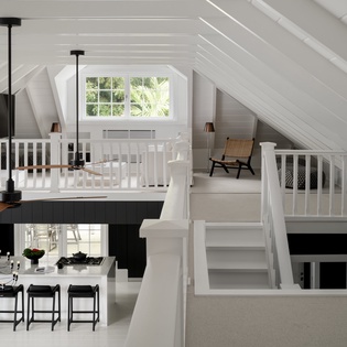 Unwind in your private loft sanctuary with cathedral ceilings and cozy reading nook, overlooking the stylish kitchen below.