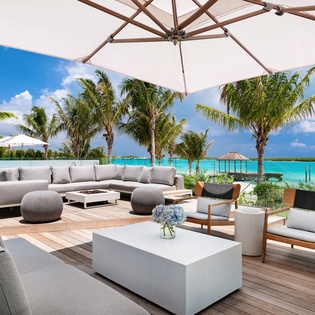 Sink into plush seating with turquoise waters and swaying palms as your backdrop. Your private paradise awaits with pool access and tropical views.