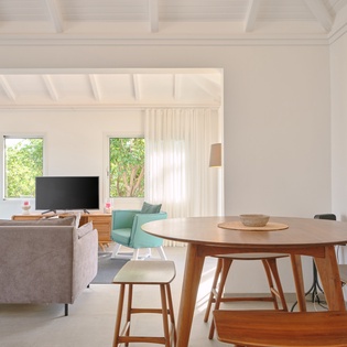 Gather around this beautiful wooden dining table with your travel companions in this bright, modern space.