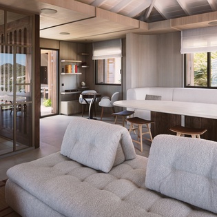 Relax in this sophisticated open-plan living space with plush seating and stunning garden views through floor-to-ceiling windows.