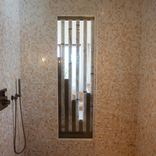 Step into your private spa-like shower with stunning mosaic tiles and modern fixtures for the ultimate relaxation.