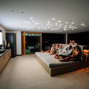 Gather friends for movie nights in your luxury home theater with cozy stadium seating and stunning starlit ceiling views.