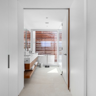 Step into your spa-like ensuite with warm wood accents, rainfall shower, and soaking tub for ultimate relaxation.