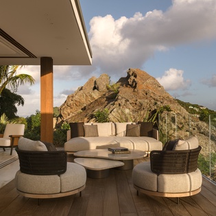 Your private terrace offers plush seating with dramatic rock formations as your backdrop, perfect for evening relaxation.