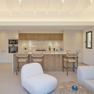 Your open-plan kitchen flows seamlessly into the living space, with modern appliances and warm wood accents creating the perfect spot for cooking and socializing.