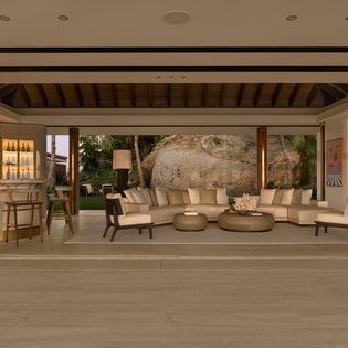 Unwind in this stunning open-air living space where natural stone meets modern comfort, perfect for your evening relaxation.