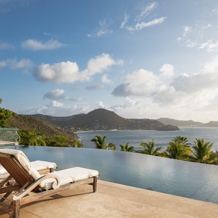 Recline by your private infinity pool and soak in uninterrupted ocean views framed by lush tropical hillsides and tranquil blue waters.