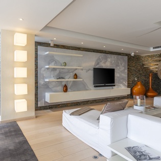 Step into your stunning living room, where modern design meets serene comfort. Sleek stone accents, ambient lighting, and plush seating invite you to unwind in style.