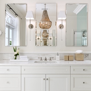 Refresh and rejuvenate in your elegant bathroom, featuring marble countertops, statement chandelier, and thoughtfully curated amenities designed for your comfort.