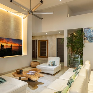 Unwind in your stylish living space with plush seating, ambient lighting, and a large TV for cozy evenings together.