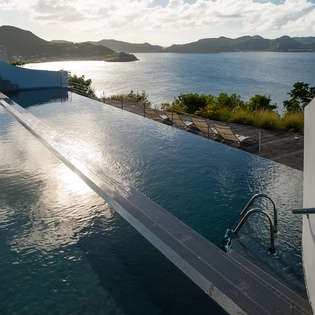 Slip into your private infinity pool where crystal-clear waters blend seamlessly with the stunning ocean horizon beyond.