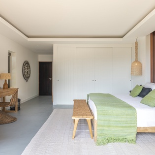 Your serene bedroom features natural wood accents, earthy tones, and modern comfort for the perfect restful retreat.