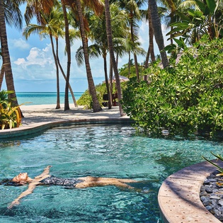 Float peacefully in your private infinity pool, surrounded by swaying palms and turquoise waters stretching to the horizon.