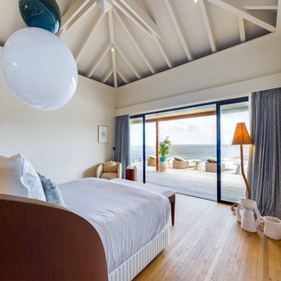 Wake up to endless ocean views through floor-to-ceiling windows, where your bedroom opens directly to a private terrace overlooking the sea.