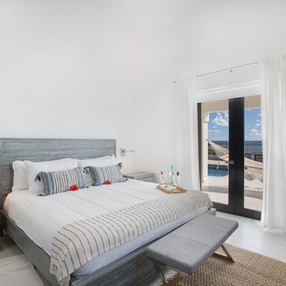 Wake up to stunning sea views from your bright, serene bedroom. Crisp linens, coastal-inspired decor, and direct access to your private balcony create a peaceful retreat.