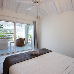 Wake up to stunning views from your peaceful bedroom, where vaulted ceilings and gentle breezes create the perfect retreat.