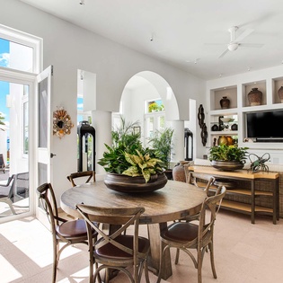 Step into your bright, airy living space where tropical elegance meets comfort. Gather at the handcrafted dining table, relax in the curated lounge, and let ocean breezes flow through open doors to your private terrace.