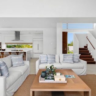 Relax in your spacious open-plan living area where plush seating and modern design create the perfect retreat for unwinding together.