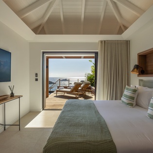 Wake up to breathtaking ocean views from your serene bedroom, where coastal breezes flow through the private terrace and every detail invites relaxation.
