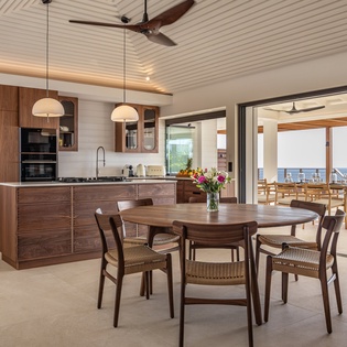 Your gourmet kitchen and dining area flows seamlessly to the terrace, where ocean views create the perfect backdrop for memorable meals.