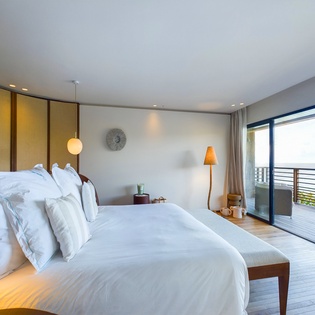Wake up to stunning views in your elegant bedroom with luxurious bedding and private balcony access.